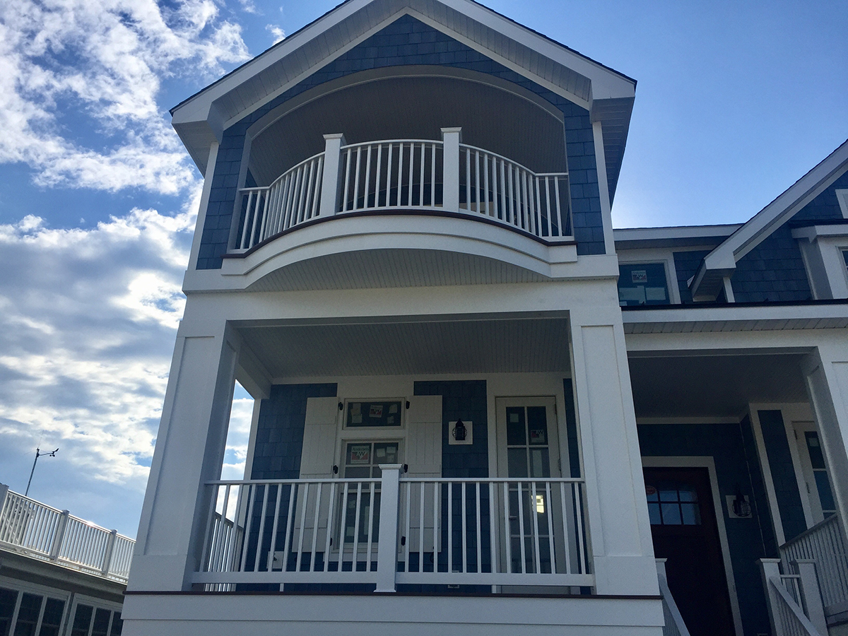 White railing on blue vinyl building